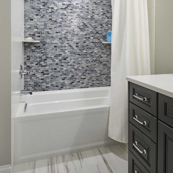 lower-level-shower-with-blue-mosaic-tile-wall tub shower with blue mosaic tile