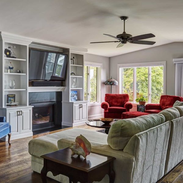 remodeled-condo-lake-geneva-by-orren-pickell living room with tv above fireplace