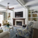 classic living room with coffered ceiling and built-in bookscases