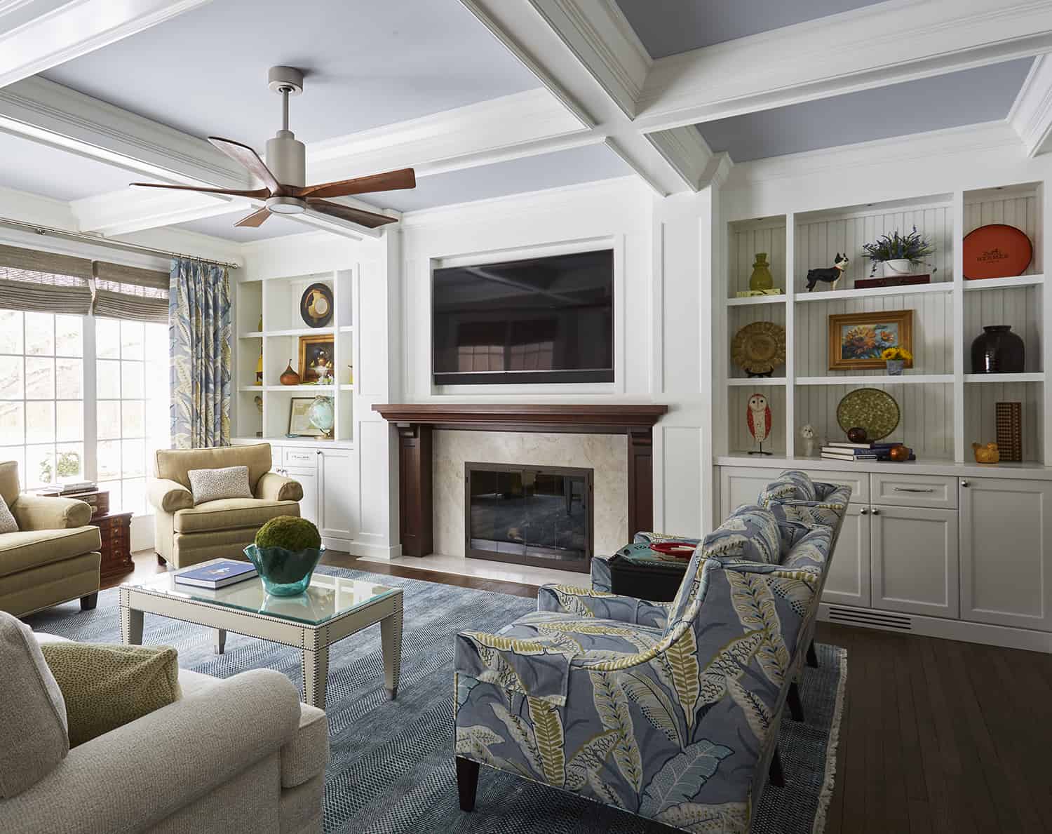 classic living room with coffered ceiling and built-in bookscases