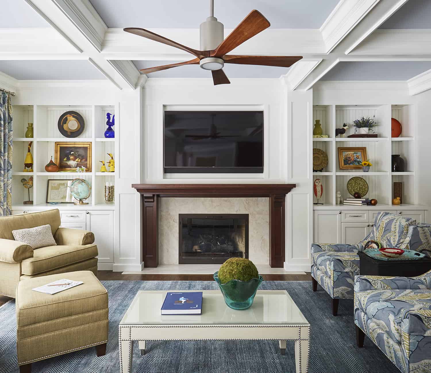 fireplace wall with bookcases on both sides and tv