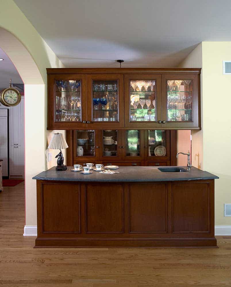 dark wood buffet cabinetry with glass uppers