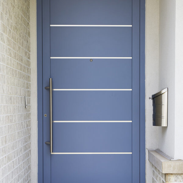 blue-front-door-metal-inserts closeup of blue front door with metal inserts