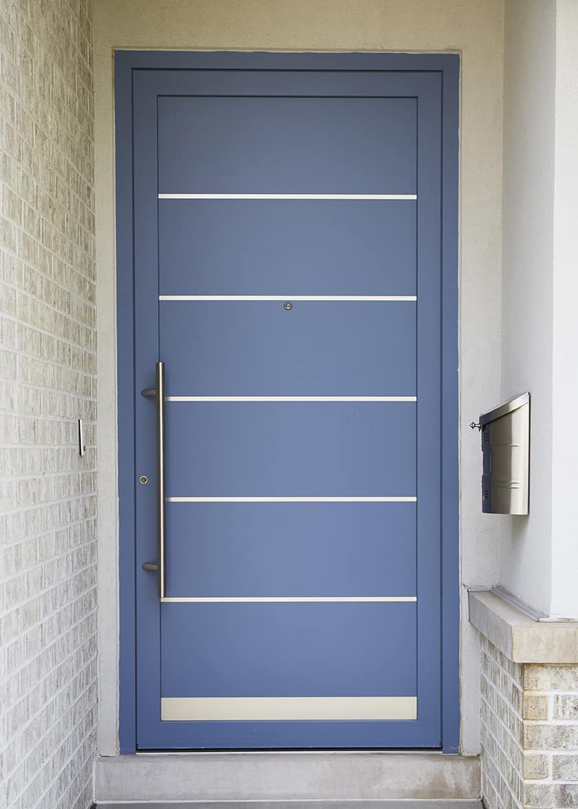 closeup of blue front door with metal inserts