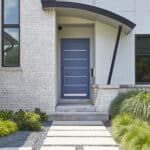 modern blue door with curved canopy