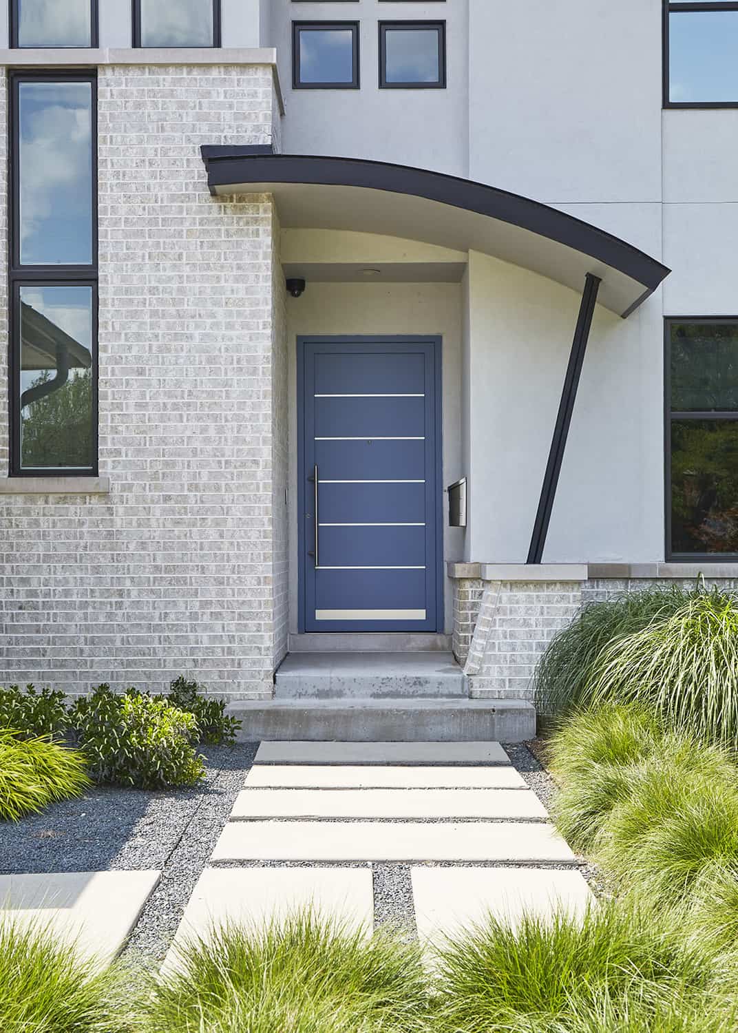 modern blue door with curved canopy