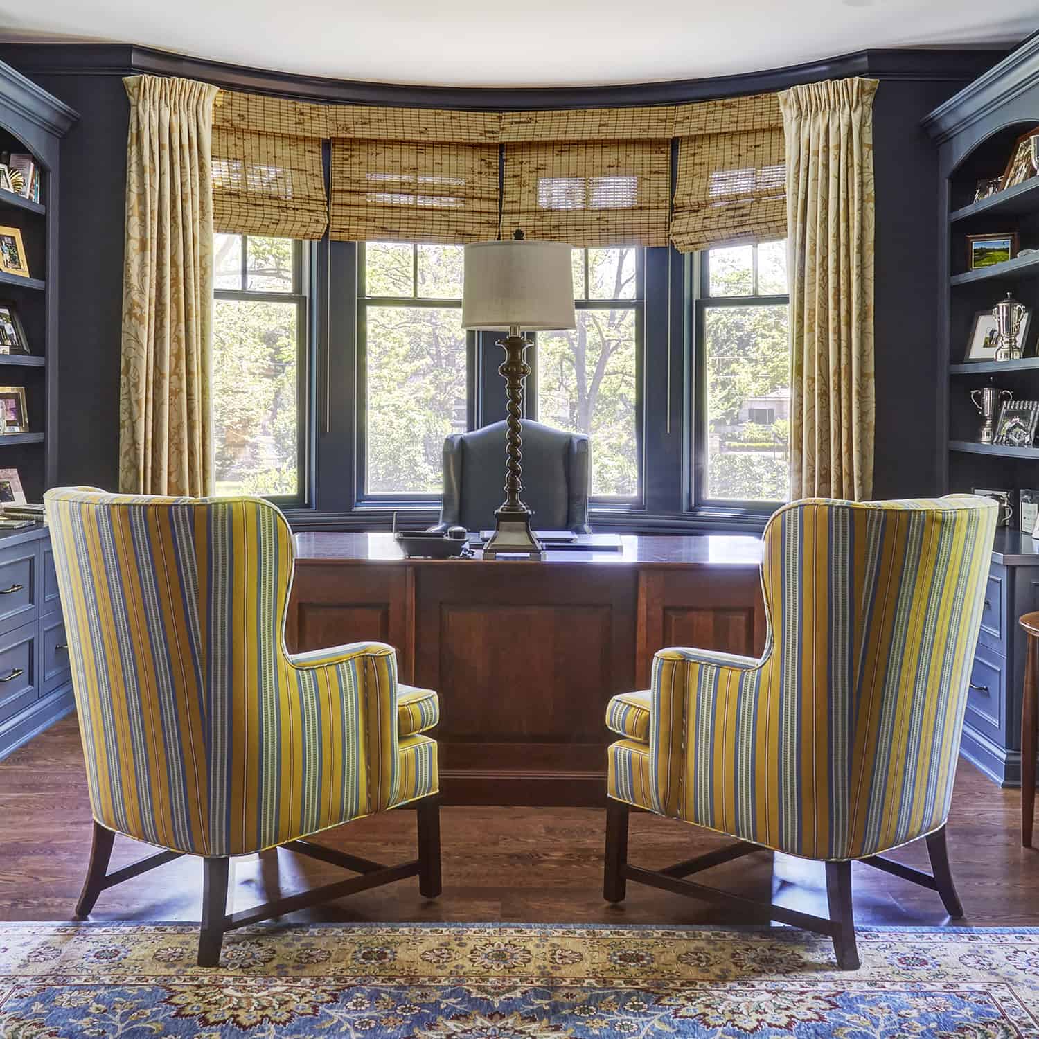 home office with blue and yellow striped chairs and blue cabinets