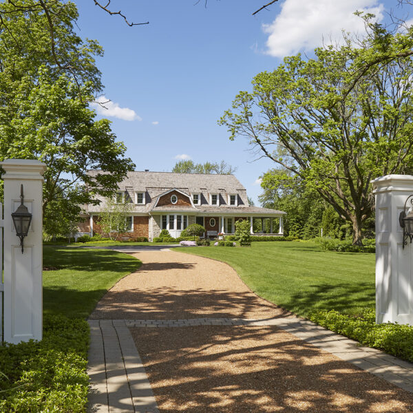 driveway-approach-lake-forest-shingle-style-home gravel driveway leading to house