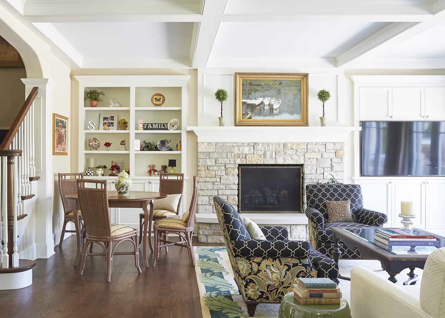 family room with coffered ceiling and stone fireplace