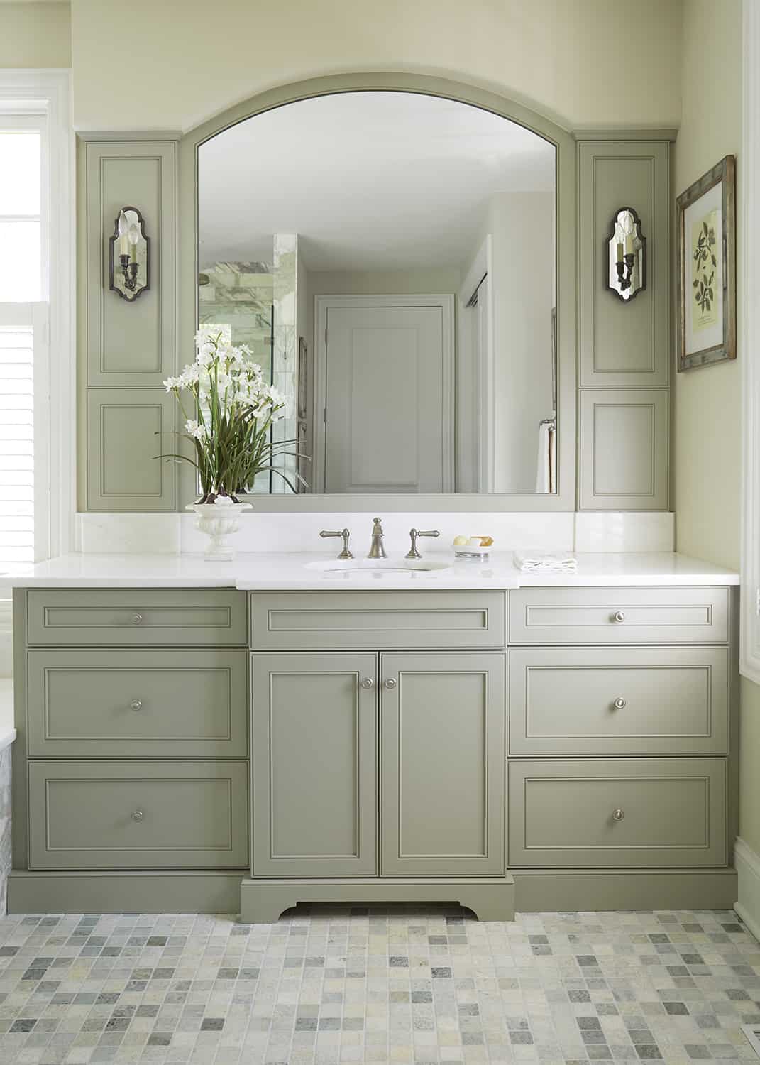 light green vanity cabinet with arched mirror