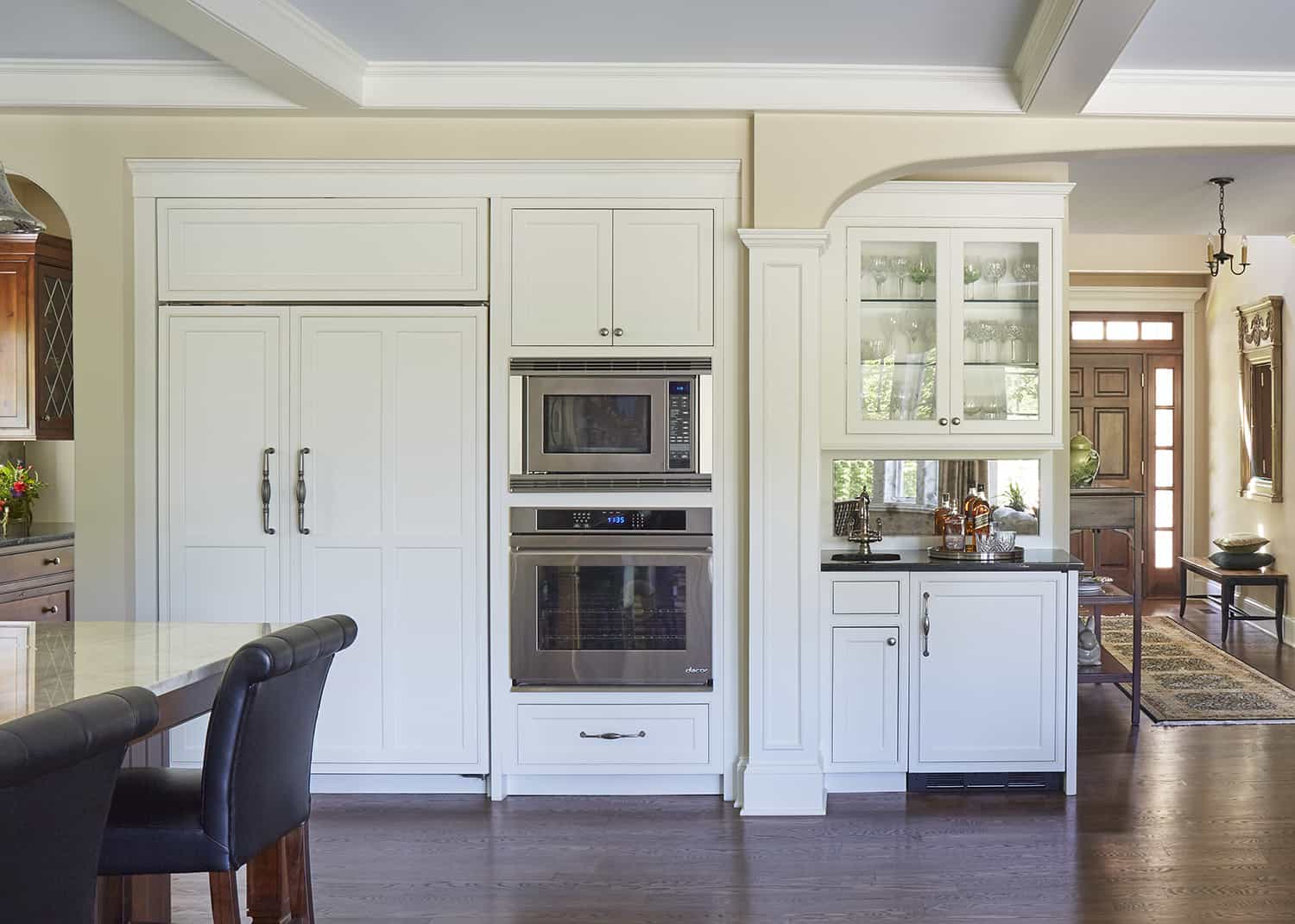 white cabinets with paneled refrigerator