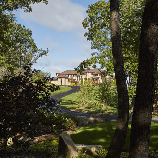 driveway-approach house view from woods afar