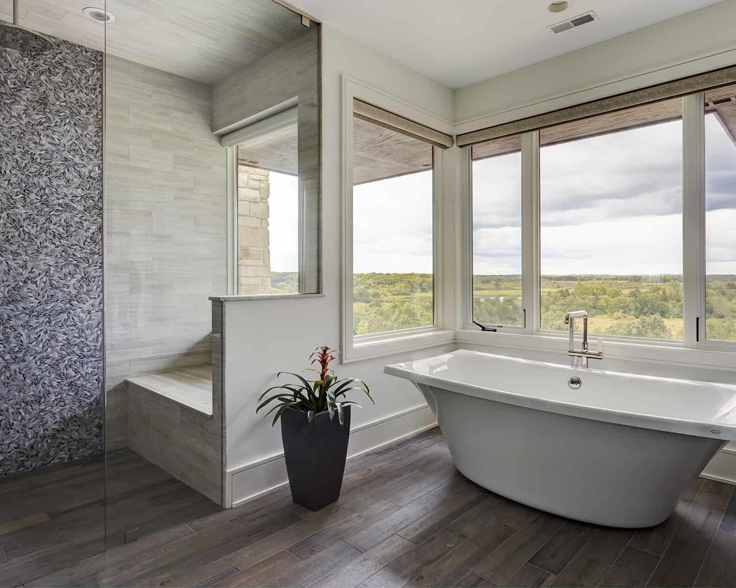 freestanding tub in front of windows