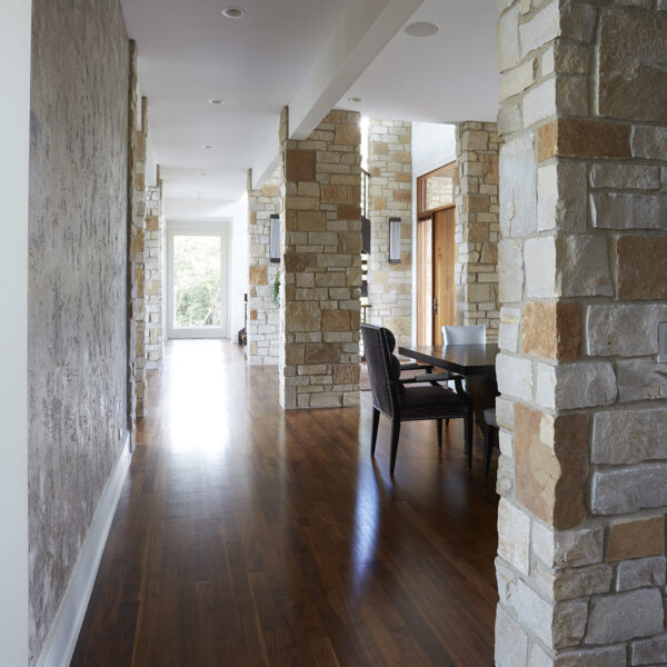 hallway-proportion generous hallway with wood floor stone columns