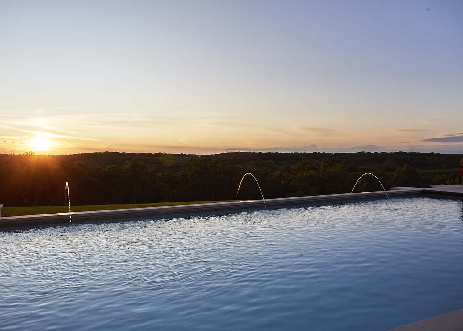 sun setting over pool