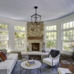 sunroom addition with stone fireplace