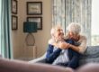senior couple hugging on couch