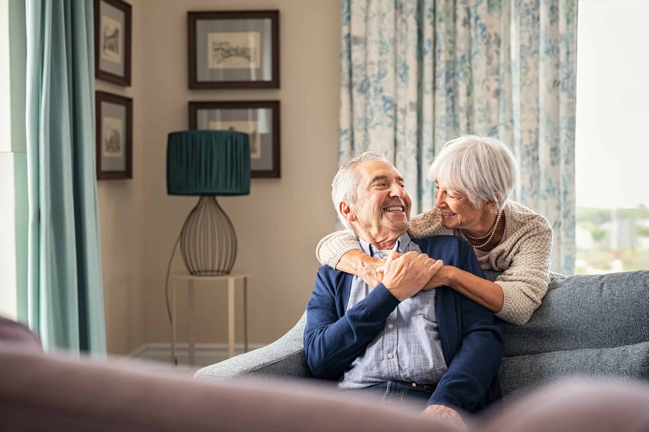 senior couple hugging on couch