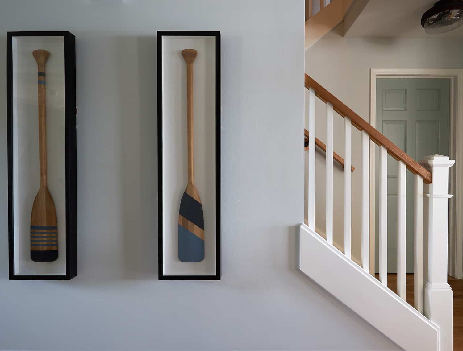 painted oars framed as wall art