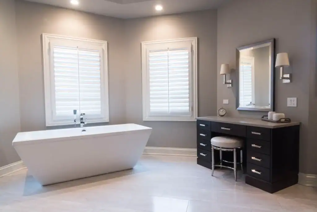 Picture of a clean modern bathroom with a freestanding tub and dark wood vanity