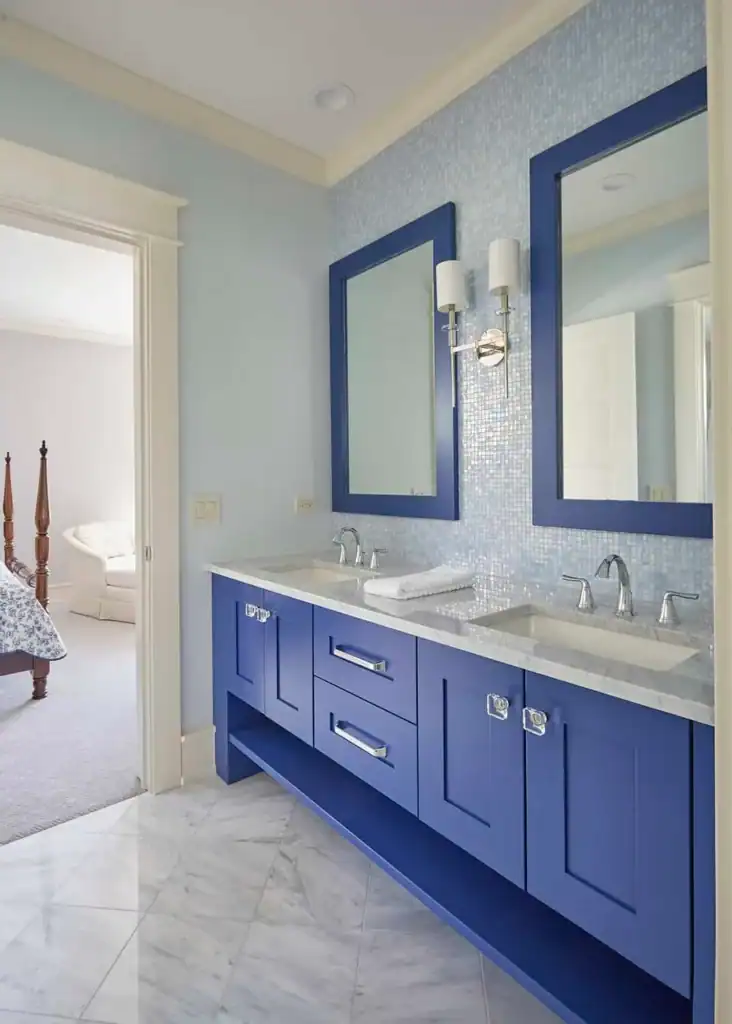 Picture of a bright blue double vanity with matching blue mosaic backsplash tiles