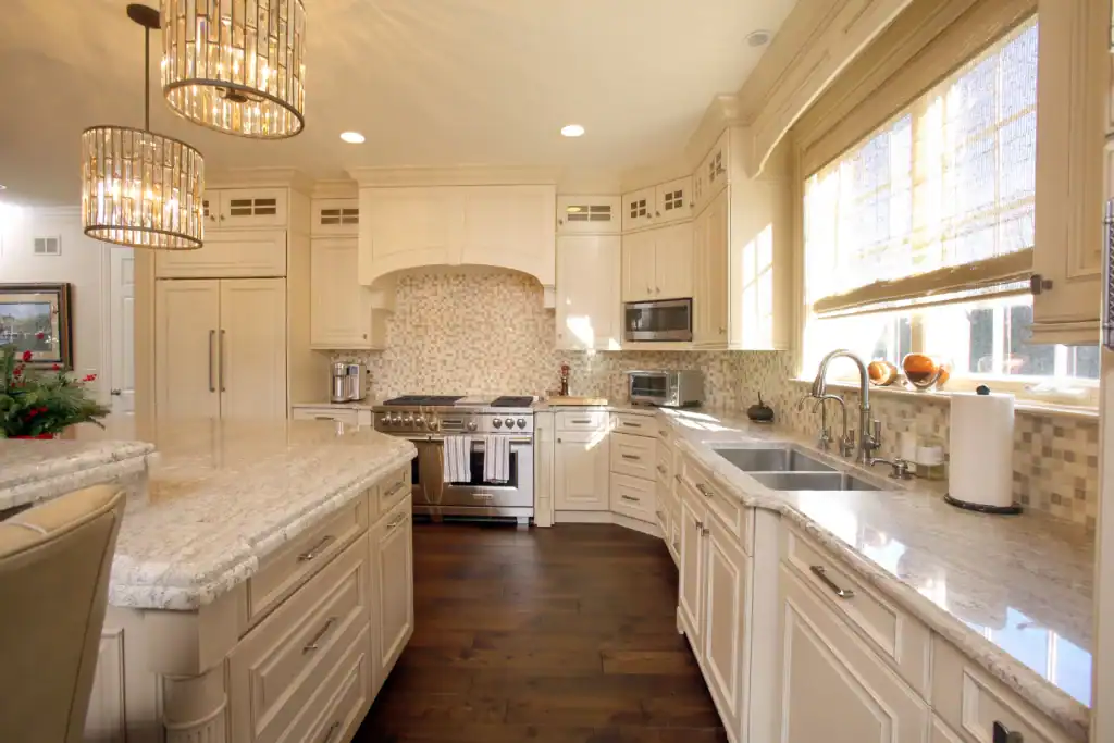 Picture of a bright custom kitchen showcasing light cabinetry and stainless steel appliances.