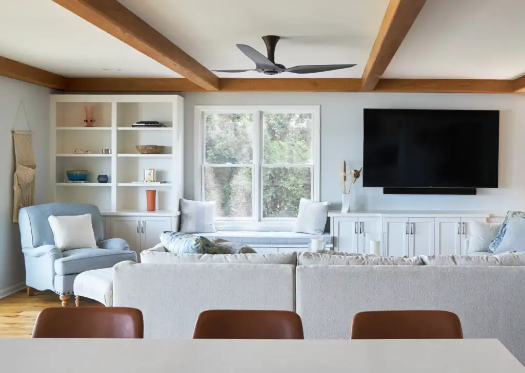 Picture of a cozy living room with exposed ceiling beams and a large TV