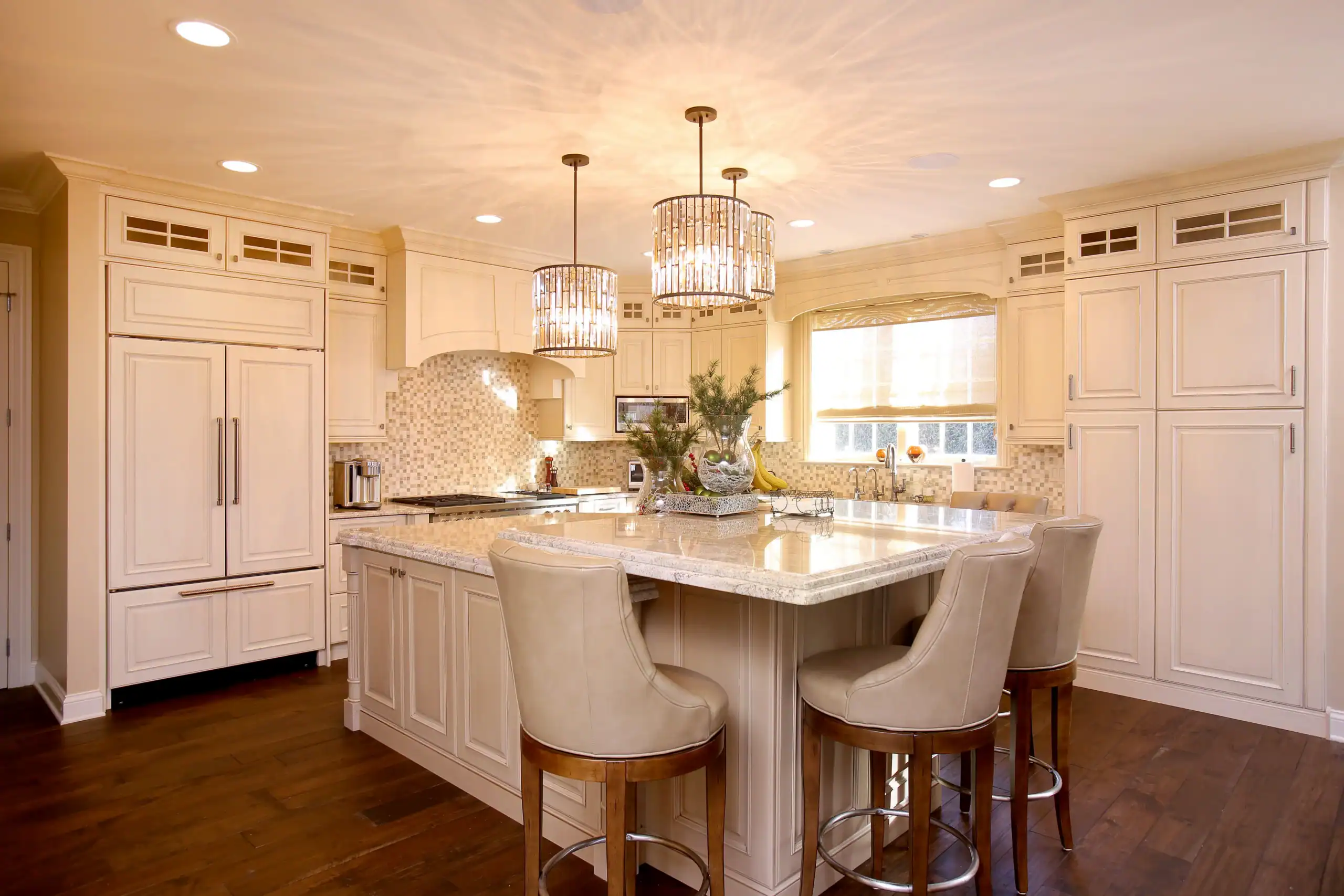 Picture of a spacious luxury kitchen featuring a large island and two crystal chandeliers. Picture of a spacious luxury kitchen featuring a large island and two crystal chandeliers.