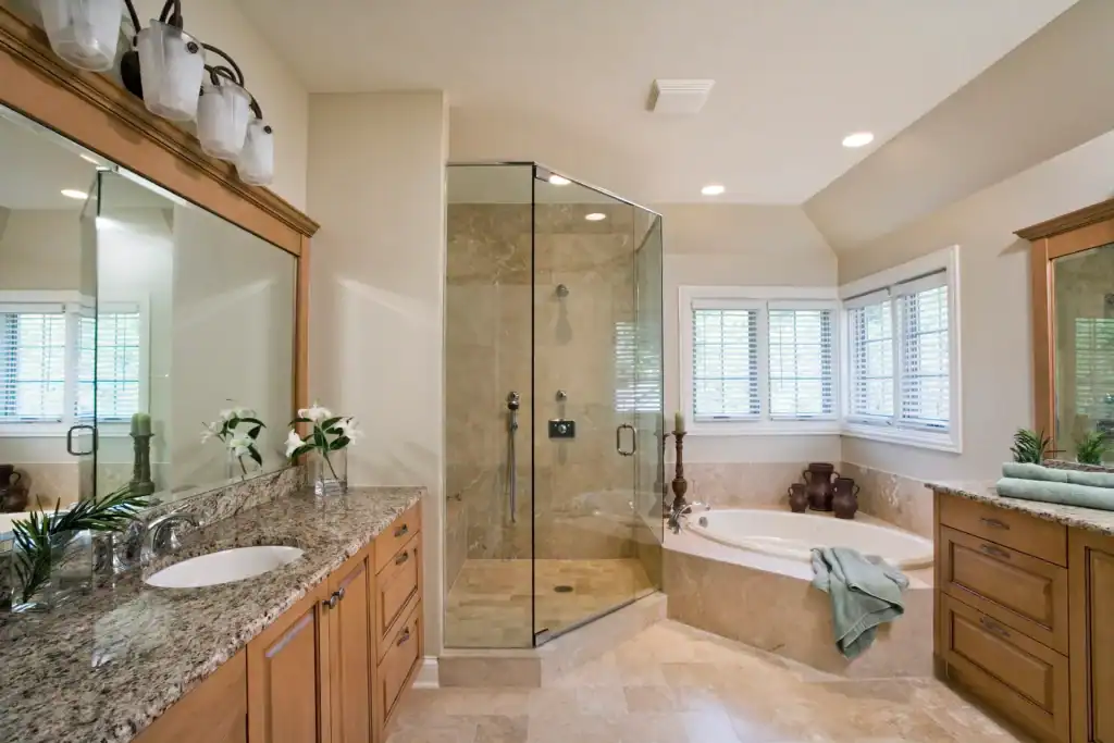 Picture of a bathroom with a corner bathtub and glass shower