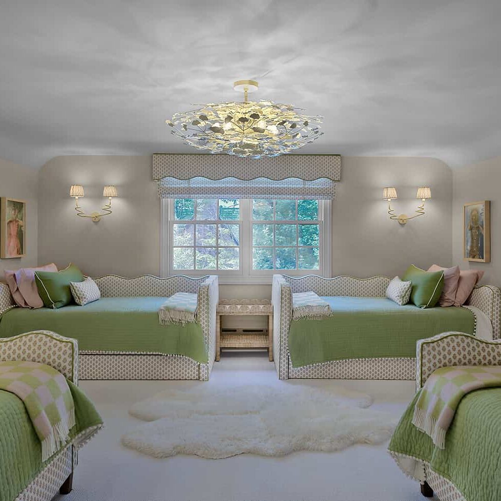 Children's bunk room with upholstered beds, designer ceiling fixture, and custom furnishings.