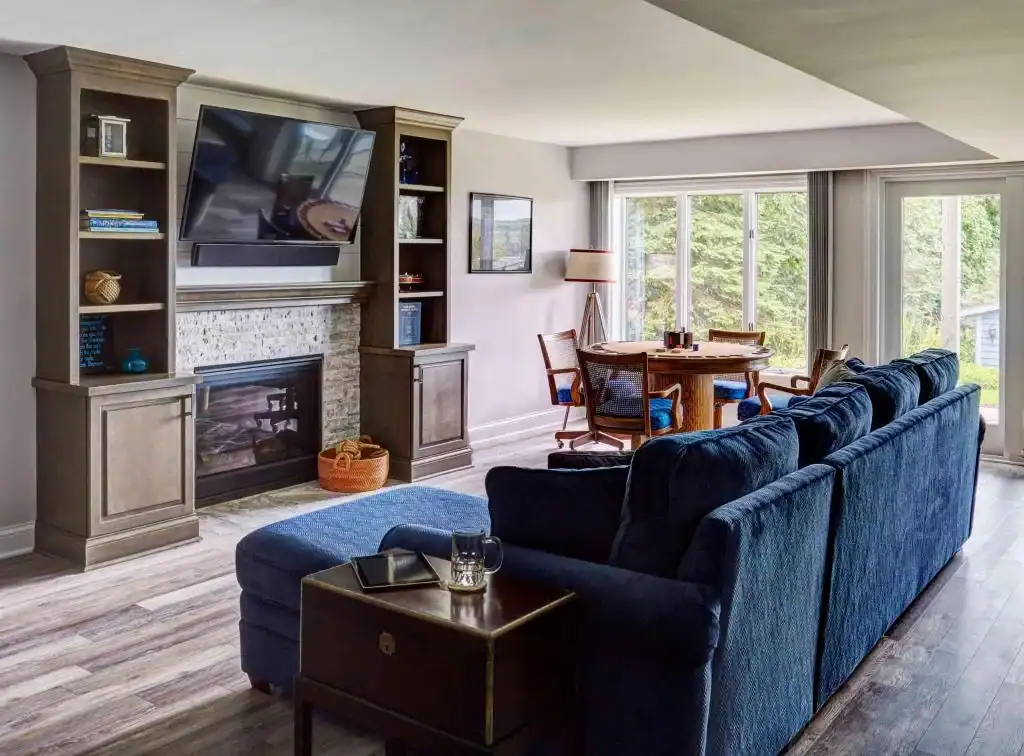Picture of a cozy living room with a blue sectional sofa and fireplace
