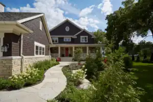 Picture of a dark brown house exterior with a stone pathway