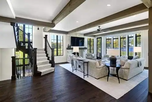 Picture of a spacious living room with dark wood floors and exposed beams