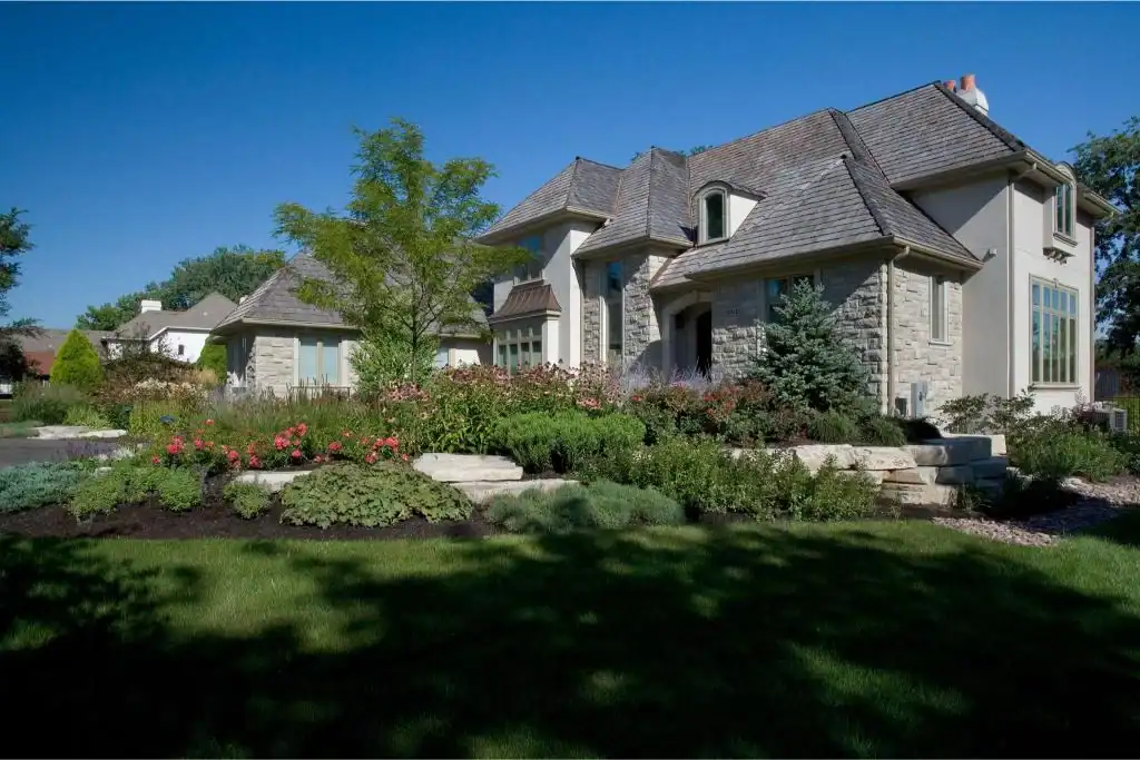 Picture of a stone house exterior with manicured landscaping