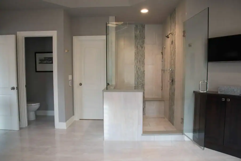 picture of a glass shower enclosure and a dark wood cabinet