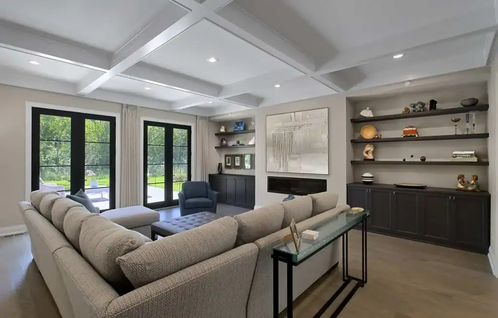 picture of a living room with grey sofa and dark cabinets