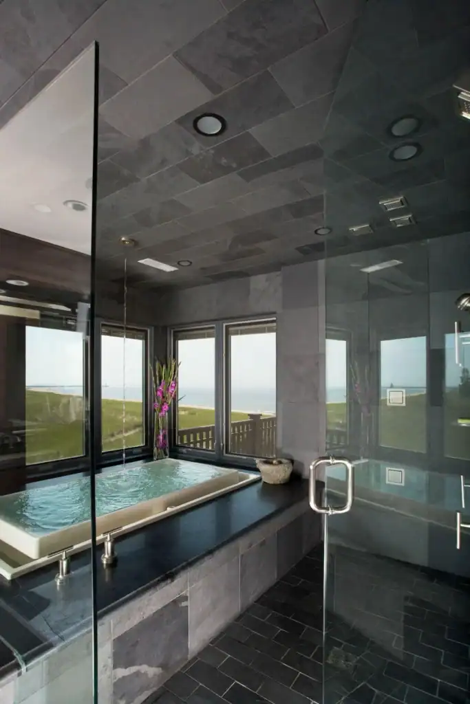 picture of a sunken tub in a dark slate bathroom