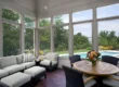 picture of a sunroom overlooking a backyard pool